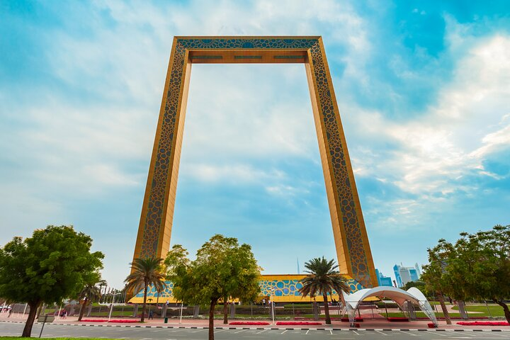 Discover the stunning view from Dubai Frame bridging the past and future. Experience the blend of modernity and tradition with lush surroundings highlighting the architectural wonder.